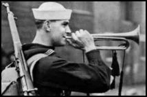 Photograph of a sailor playing a bugle